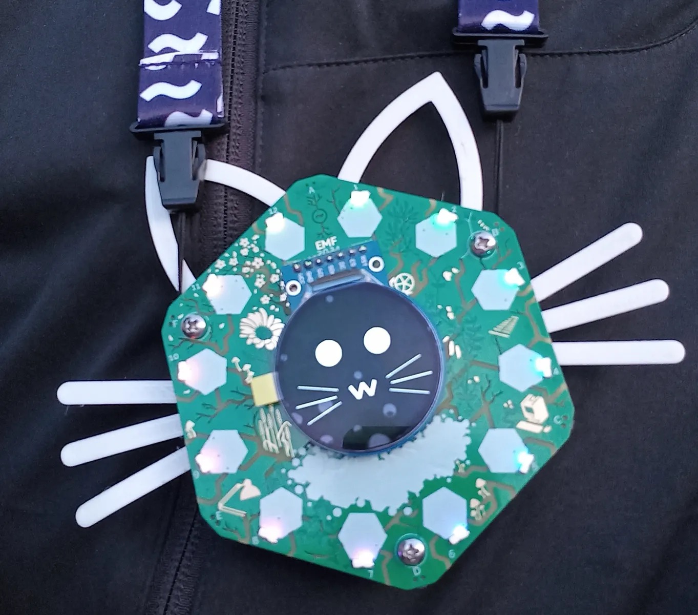 Stylised white cat ears on the top two edges and cat whiskers on the two side edges of a Tildagon by catnerd.